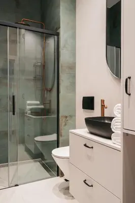 a bathroom with a glass shower and a sink at Native Apartments Długa 24I3 in Kraków