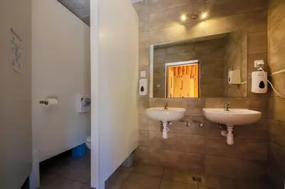 a bathroom with two sinks and a mirror at Kemping i Pole Namiotowe River Park Zator SPA RESORT in Zator