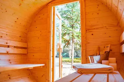 an inside view of a wooden cabin with a window at Kemping i Pole Namiotowe River Park Zator SPA RESORT in Zator