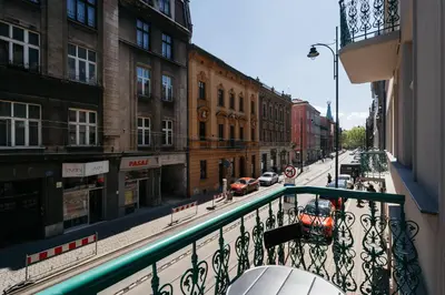 a bedroom with a bed and a couch at Native Apartments Długa 24I4 in Kraków