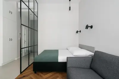 a black refrigerator in a kitchen next to a microwave at Native Apartments Długa 24I4 in Kraków