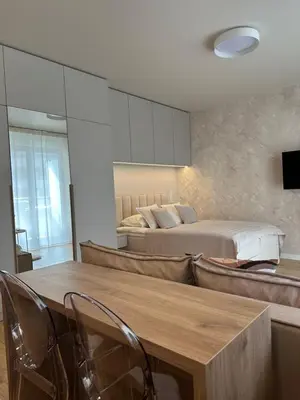 a bedroom with a bed and a table and chairs at Kaskada Apartment in Kraków