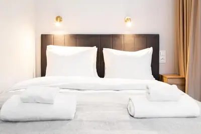 a bedroom with two beds with white sheets and pillows at Househost Apartment Smoleńsk Elegant Studio AC Lift Security in Kraków
