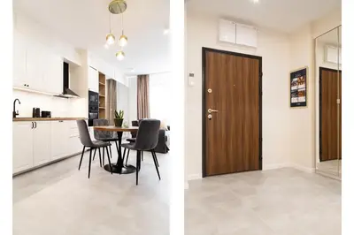 a kitchen and a dining room with a wooden door at Househost Apartment Smoleńsk Elegant Studio AC Lift Security in Kraków
