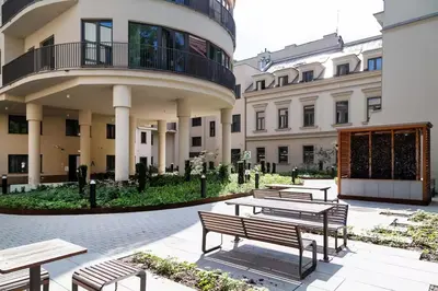 a group of benches in front of a building at Househost Apartment Smoleńsk Elegant Studio AC Lift Security in Kraków