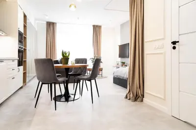 a kitchen and dining room with a table and chairs at Househost Apartment Smoleńsk Elegant Studio AC Lift Security in Kraków
