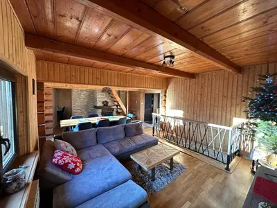 a living room with a couch and a christmas tree at Gorczańska Chata Lubomierz in Lubomierz