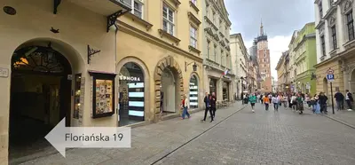 a group of people walking down a city street at Pawia Apartments Old Town in Kraków