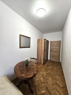 a living room with a table and a couch at Pawia Apartments Old Town in Kraków