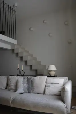 a living room with a couch and a staircase at Stradom Studio in Kraków