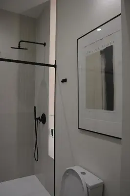a bathroom with a toilet and a picture on the wall at Stradom Studio in Kraków