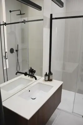 a bathroom with a sink and a shower at Stradom Studio in Kraków