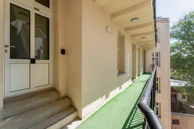 a walkway with a door and stairs on a building at Cozy studio - Starowislna 54 Street in Kraków