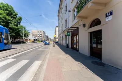 an empty street in a city with a bus at Cozy studio - Starowislna 54 Street in Kraków