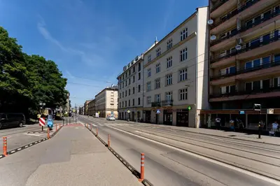 an empty street in a city with buildings at Cozy studio - Starowislna 54 Street in Kraków