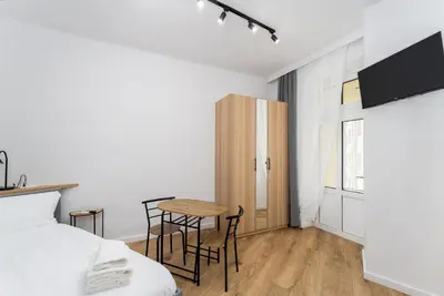 a bedroom with a bed and a table and chairs at Cozy studio - Starowislna 54 Street in Kraków