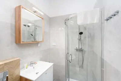 a bathroom with a shower and a sink at Cozy studio - Starowislna 54 Street in Kraków