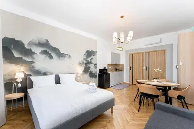 a bedroom with a bed and a dining room at Cozy Studio - Starowislna 54 in Kraków