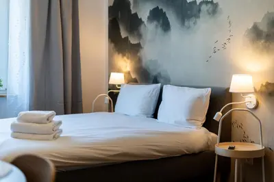 a bedroom with a bed with towels on it at Cozy Studio - Starowislna 54 in Kraków