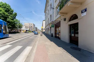 an empty street in a city with a bus at Cozy Studio - Starowislna 54 in Kraków