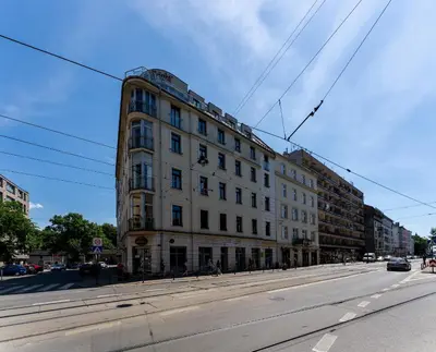 a large white building on the side of a street at Cozy Studio - Starowislna 54 in Kraków