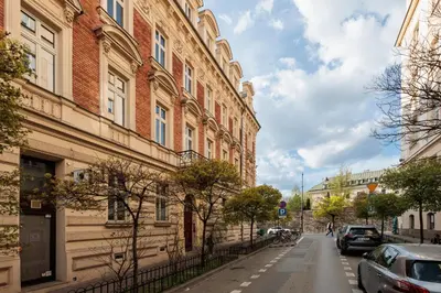 a street in a city with buildings and cars at Urban Light Apartment - 3' Main Square - by Upstairs in Kraków