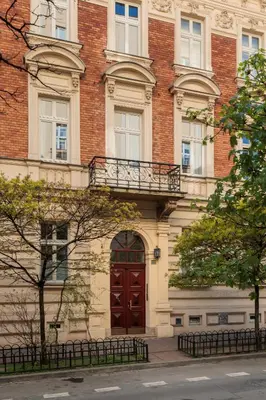 a large brick building with a red door at Urban Light Apartment - 3' Main Square - by Upstairs in Kraków