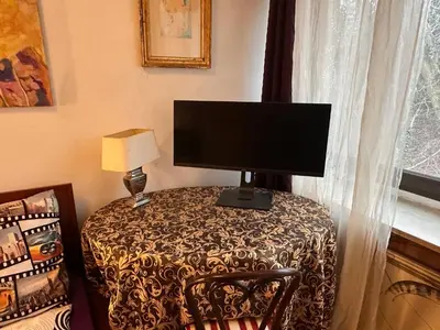 a computer monitor sitting on a table with a chair at Villatopol in Rząska