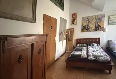 a bedroom with a bed and a wooden cabinet at Villatopol in Rząska