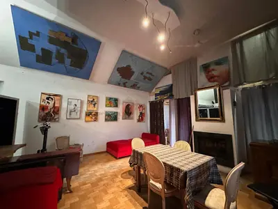 a living room with a table and a red couch at Villatopol in Rząska