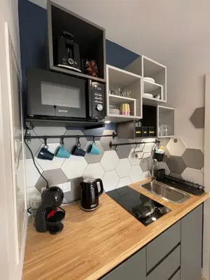 a kitchen with a counter with a sink and a microwave at Sunflower Apartment Bałuckiego Street in Kraków