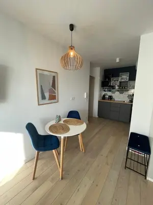 a living room with a table and two chairs at Sunflower Apartment Bałuckiego Street in Kraków