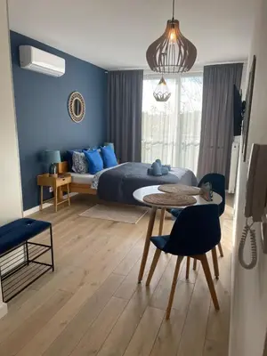 a bedroom with a bed and a table and chairs at Sunflower Apartment Bałuckiego Street in Kraków