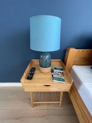 a lamp on a table next to a bed at Sunflower Apartment Bałuckiego Street in Kraków