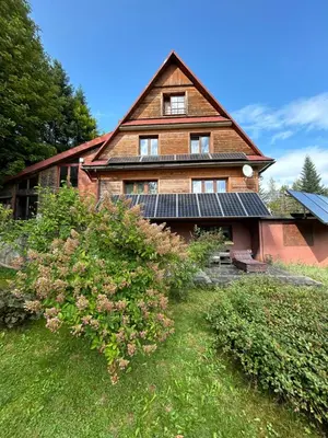 a house with solar panels on the side of it at Dom pod Cuplikiem in Zawoja