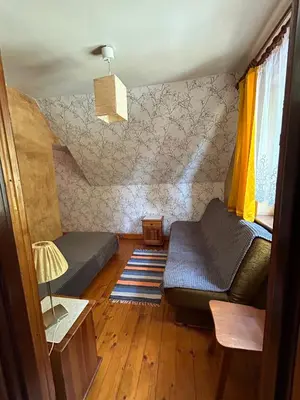 a small room with two beds and a couch at Dom pod Cuplikiem in Zawoja