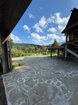 a stone patio in front of a building at Dom pod Cuplikiem in Zawoja