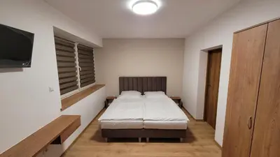 a bedroom with a bed and a flat screen tv at Wiślana 4 in Spytkowice