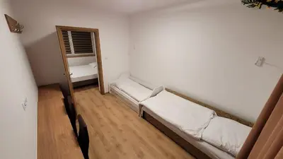 a small room with a bed and a mirror at Wiślana 4 in Spytkowice