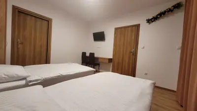 a hotel room with two beds and a desk at Wiślana 4 in Spytkowice