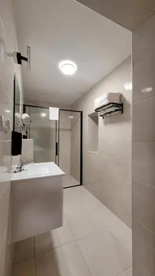 a bathroom with a white sink and a shower at Wiślana 4 in Spytkowice