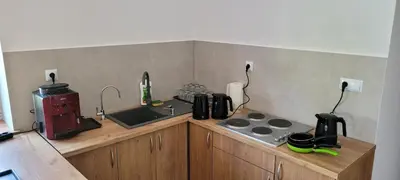 a kitchen counter with a stove and a sink at Wiślana 4 in Spytkowice