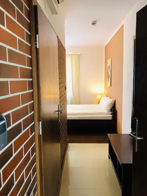 a door to a room with a bed in the background at Hotel Olecki in Oświęcim