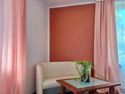 a living room with a chair and a table at Hotel Olecki in Oświęcim