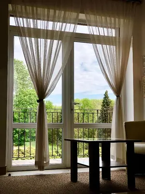 a room with a large window with a table in front at Hotel Olecki in Oświęcim
