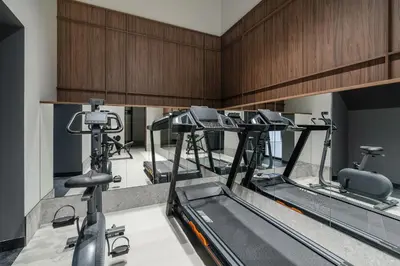 a gym with a row of tread machines at So Soho Spa Collection in Kraków