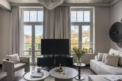 a living room with a couch and a tv at So Soho Spa Collection in Kraków