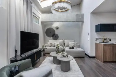 a living room with a couch and a table at So Soho Spa Collection in Kraków