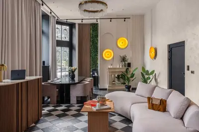 a living room with a couch and a table at So Soho Spa Collection in Kraków