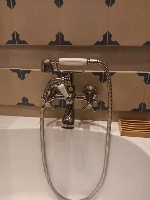 a sink with a faucet in a bathroom at Apartament Niebieski in Kraków